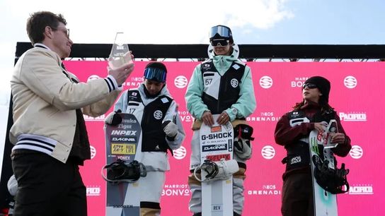 Shaun White presents the winner's trophy in the men's halfpipe competition to Yuto Totsuka of Japan as second place Ruka Hirano of Japan and third place Ayumu Hirano of Japan watch on day 2 of the Snow League event in Aspen